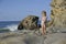 A little girl is playing on the beach.