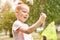 Little girl playing with butterfly net. Summer adventure. Happy toddler