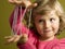 Little girl playing cats cradle game