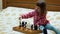 Little girl is playing chess