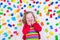 Little girl playing with colorful blocks