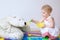 Little girl playing feeding her teddy bear