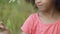 Little girl playing with flower green field, spending free time outside, nature