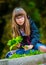 Little girl playing the green maple leaf. In the hands of a bunch of green maple leaf.