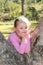 Little girl playing in a gum tree