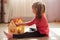 Little girl playing with her doll house. Child sitting on floor in her bedroom, female kid plays in her room at home or