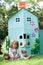 Little Girl Playing In Home Made Cardboard House