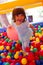 Little girl playing in inflatable bouncing castle