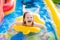 Little girl playing in inflatable garden swimming pool