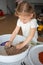 Little girl playing with kinetic sand and toys insect. Sensory development and experiences, themed activities with
