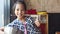 Little girl playing with kitchen toy as a cook