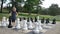 Little girl is playing large outside chess in the park. Active child, happy childhood concepts