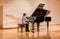 Little girl playing the piano at the concert