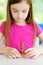 Little girl playing with a pile of coins. Child learning how to count money