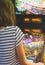 Little girl playing pinball game.