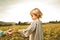 Little girl playing with plants in the field