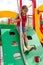 Little girl playing on playground, sliding down the wooden wall