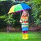Little girl playing in the rain under colorful umbrella