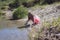 Little girl playing at riverbank