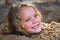 Little girl playing in sandpit