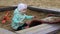 Little girl playing with a shovel in the sandbox