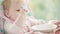 Little girl playing with spoon. Portrait of cute infant eating by herself