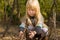 Little girl playing with sticks in woodland