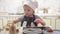 Little girl playing in a stylish wooden children`s kitchen