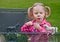 Little Girl Playing with Toy Horses