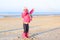 Little girl playing on winter beach