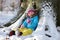 Little girl playing in winter forest