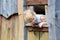 Little girl playing in wooden house in the park