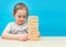 Little girl playing with wooden jenga game