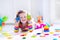 Little girl playing with wooden toys