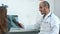 Little girl playing with xray image held by smiling male doctor