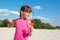 Little girl plays badminton on the beach. The concept of sports and active games in summer, recreation, lifestyle