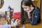 Little girl plays with a children`s constructor at home. Little girl playing with lots of colorful plastic blocks constructor and