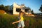 A little girl plays and dances near the construction site of her future house in the countryside. Waiting for a move, dreams of