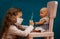 Little girl plays doctor, makes an injection to the doll