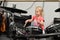 A little girl plays drums and percussion instruments at a music school