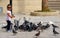 A little girl plays feeding pigeons in Heraklion