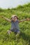 Little girl plays game with virtual reality glasses outdoors