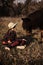 Little girl plays with horse in forest.