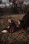 Little girl plays with horse in forest.