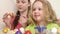 A little girl plays with a paint brush. Girls paint eggs for the Easter holiday.