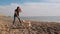 Little girl plays with stick with her amazing white shiba inu pet near the sea slow motion