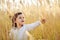 Little girl plucks a spikelets grass in the field