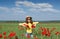 Little girl on poppies flower field