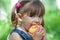 Little girl portrait eating apple outdoor