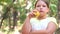Little girl portrait eating apple outdoor apple a summer day